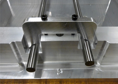 Guide rail biasing clamps.