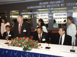 Paul Gray, Chairman of the MIT Corporation, signs agreement between MIT, King Mongkut University of Technology and the National Science and Technology Development Agency, Thailand for a program in science and technology.